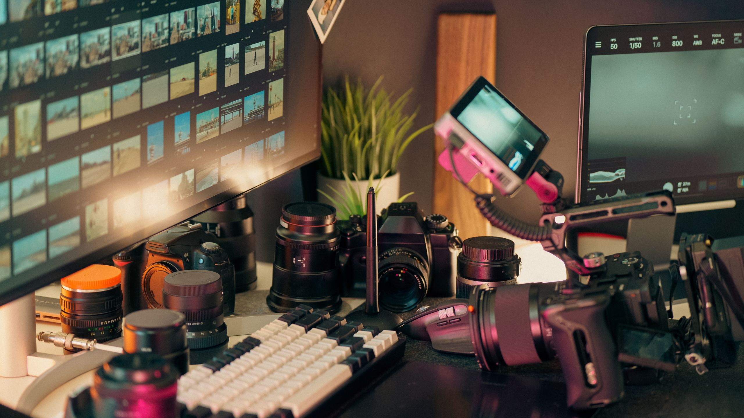 High-end content production workspace with cameras, lenses and editing monitors