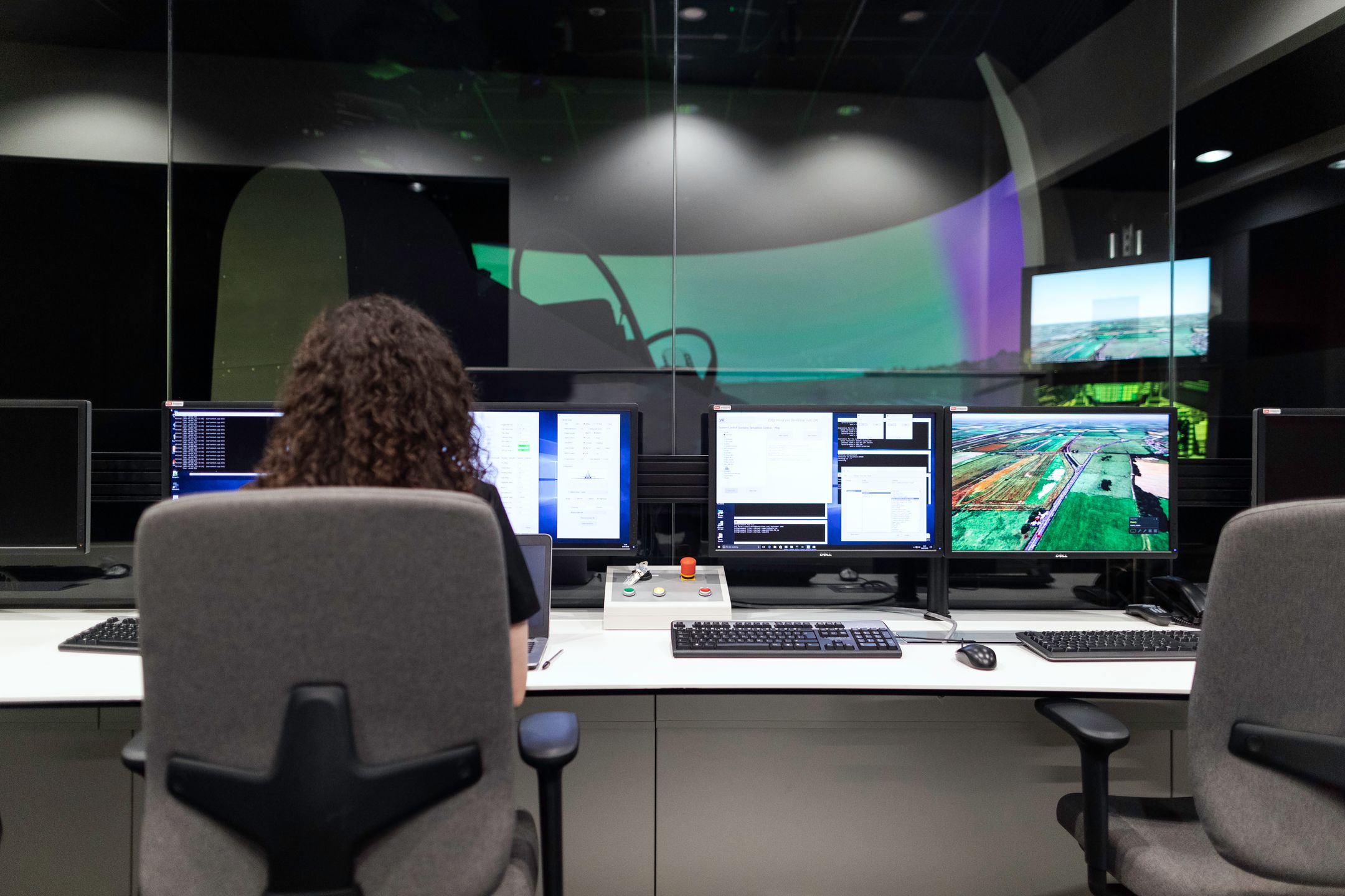 Engineer operating a multi-monitor control room — visual metaphor for a programmatic marketing workstation